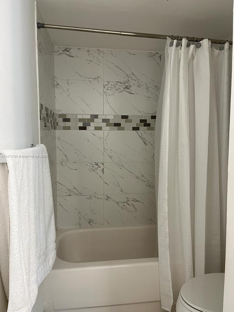 8340 Sands Point Boulevard, Unit P309 Tamarac, FL 33321 - Photo 33 of 33 a bathroom with a shower and a toilet