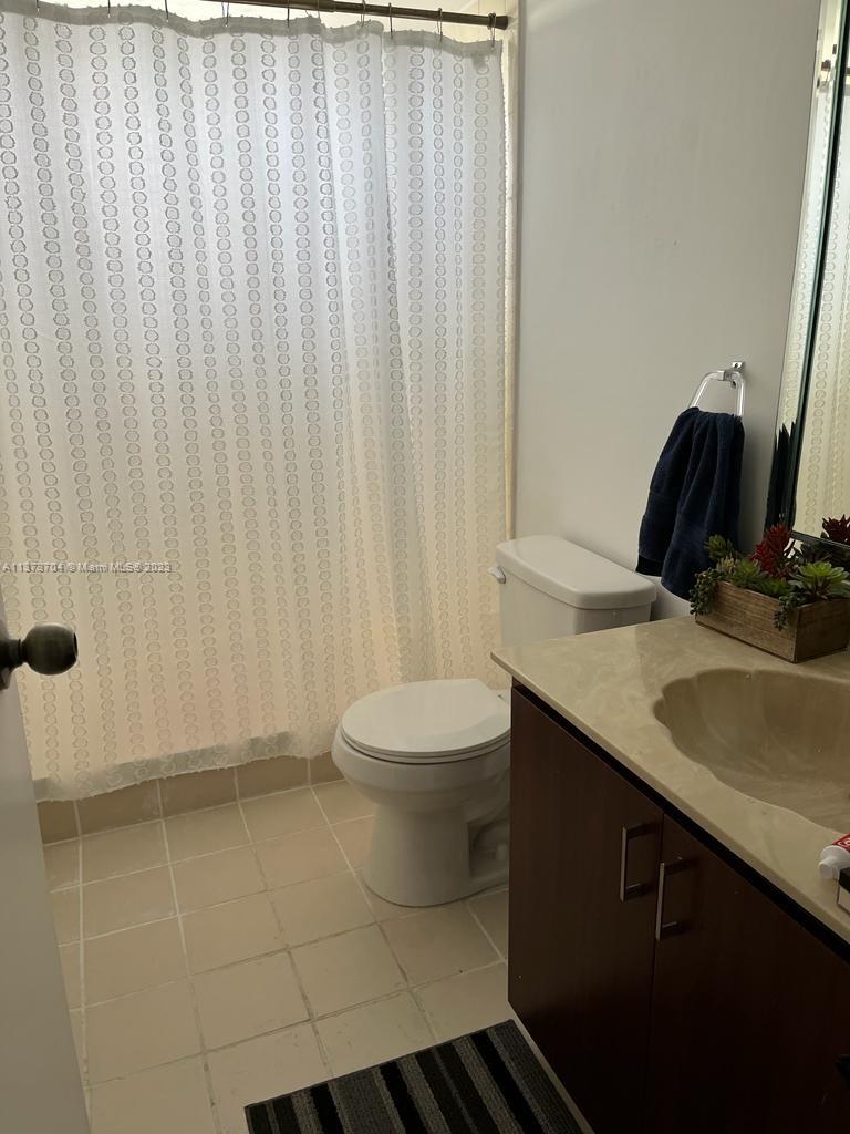 8340 Sands Point Boulevard, Unit P309 Tamarac, FL 33321 - Photo 4 of 33 a bathroom with a sink a toilet and shower