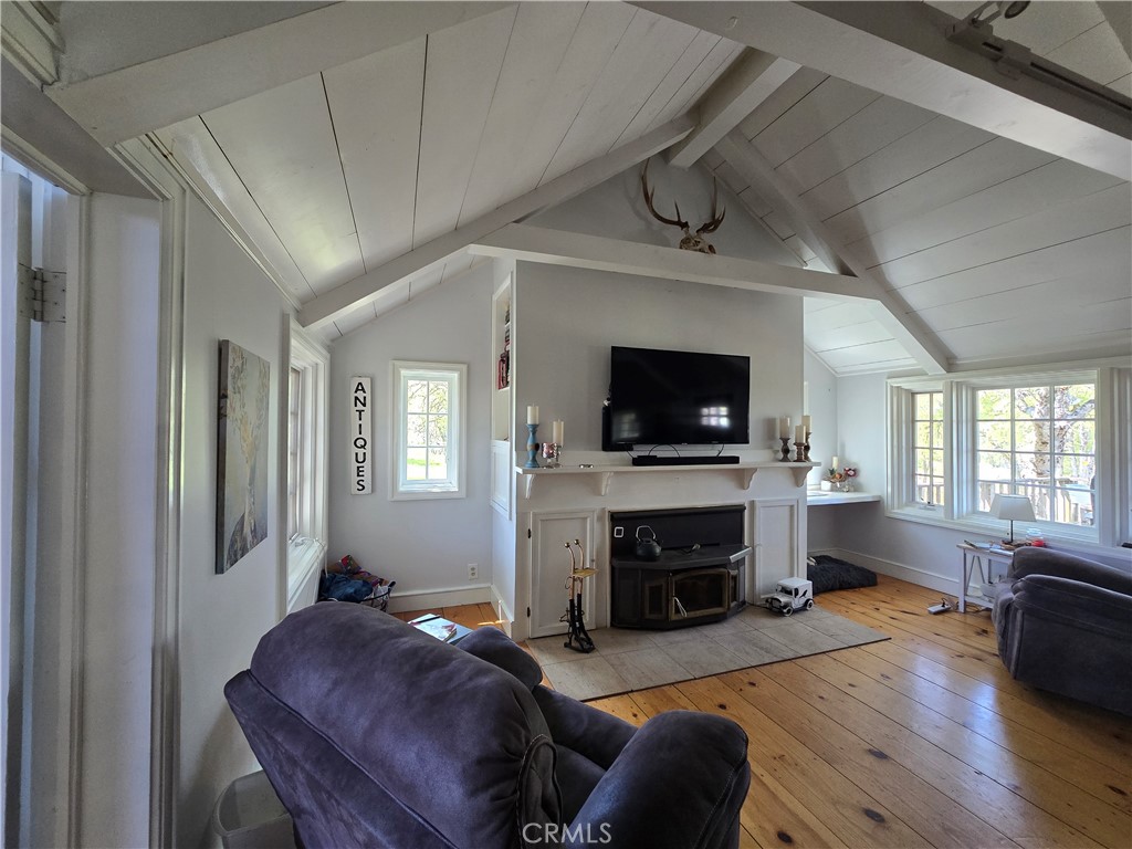 5963 Schilling Road Coulterville, CA 95311 - Photo 10 of 75 a living room with furniture a flat screen tv and a fireplace