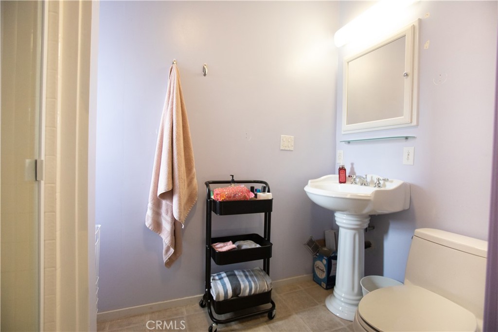 5963 Schilling Road Coulterville, CA 95311 - Photo 18 of 75 a bathroom with a sink toilet and a mirror