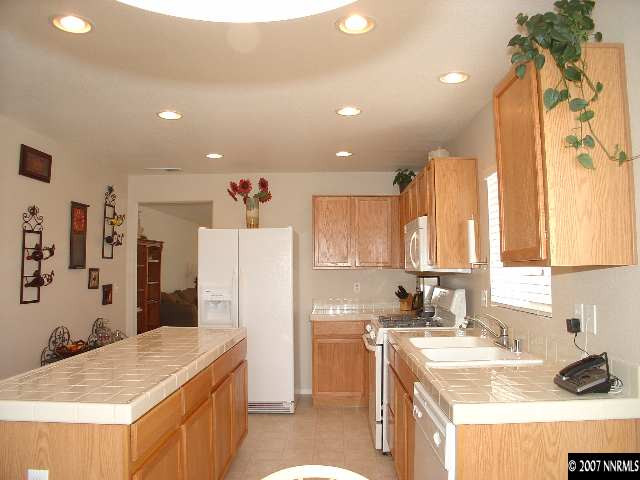 7765 Welsh Drive Reno, NV 89506 - Photo 4 of 9 a kitchen with a sink stove and refrigerator