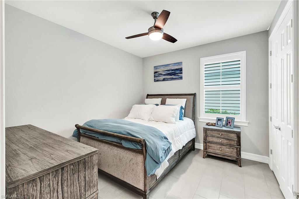 267 Tamarindo Lane Naples, FL 34114 - Photo 22 of 45 a bedroom with a bed and a chandelier