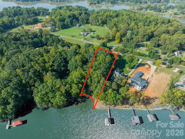 an aerial view of a house with a yard and outdoor seating