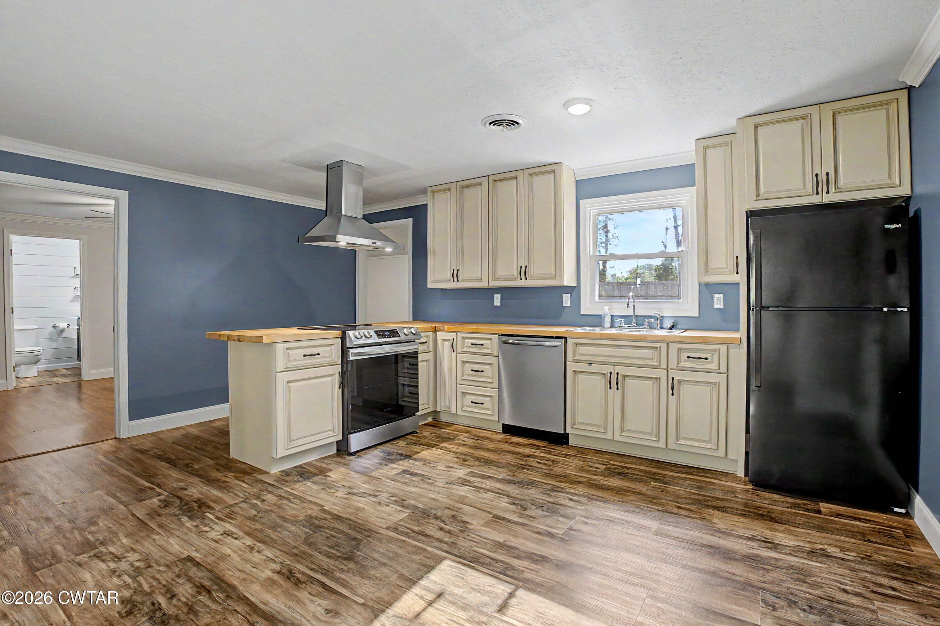 113 Church Street Gleason, TN 38229 - Photo 12 of 21 a kitchen with a refrigerator sink and cabinets