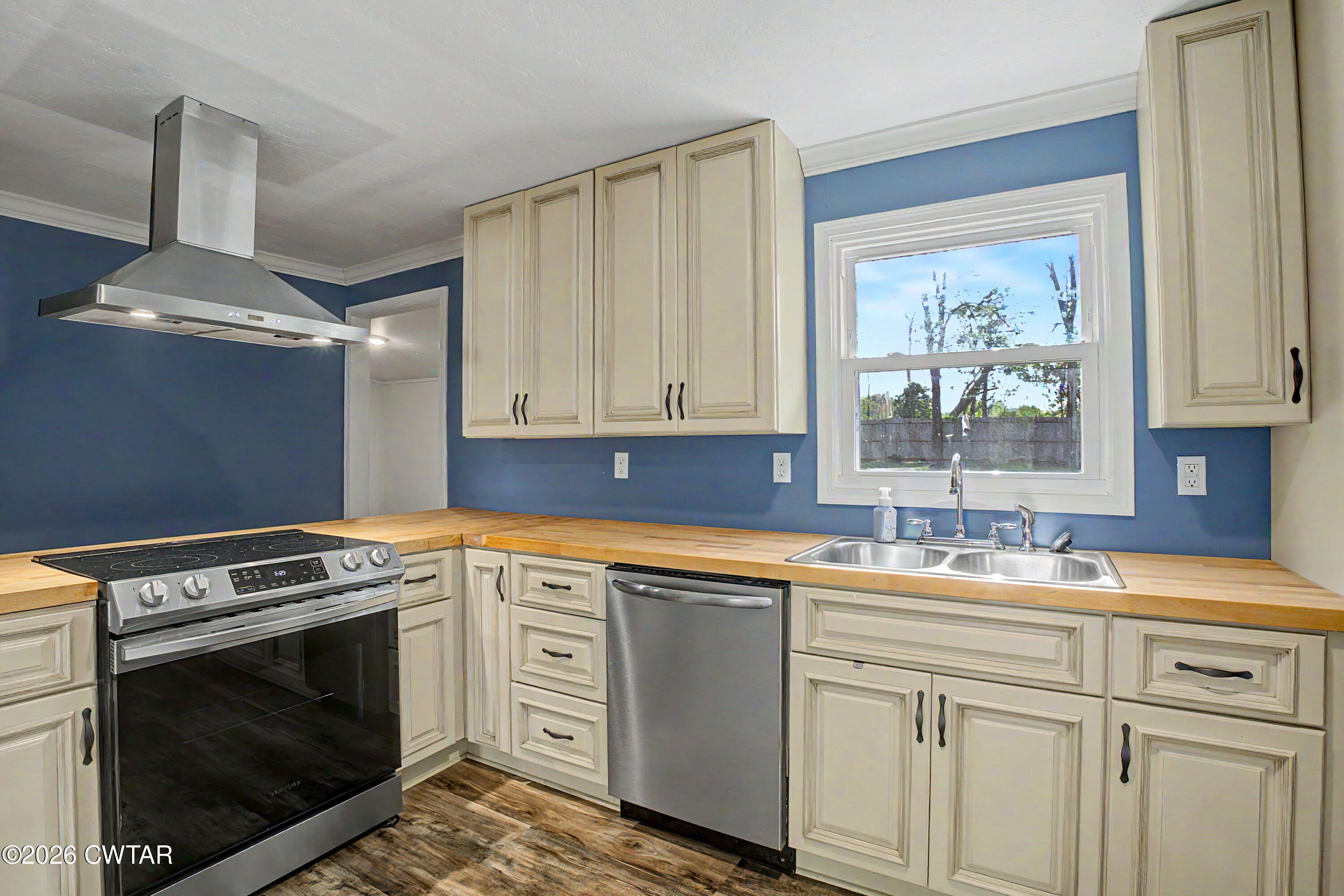 113 Church Street Gleason, TN 38229 - Photo 14 of 21 a kitchen with white cabinets and appliances