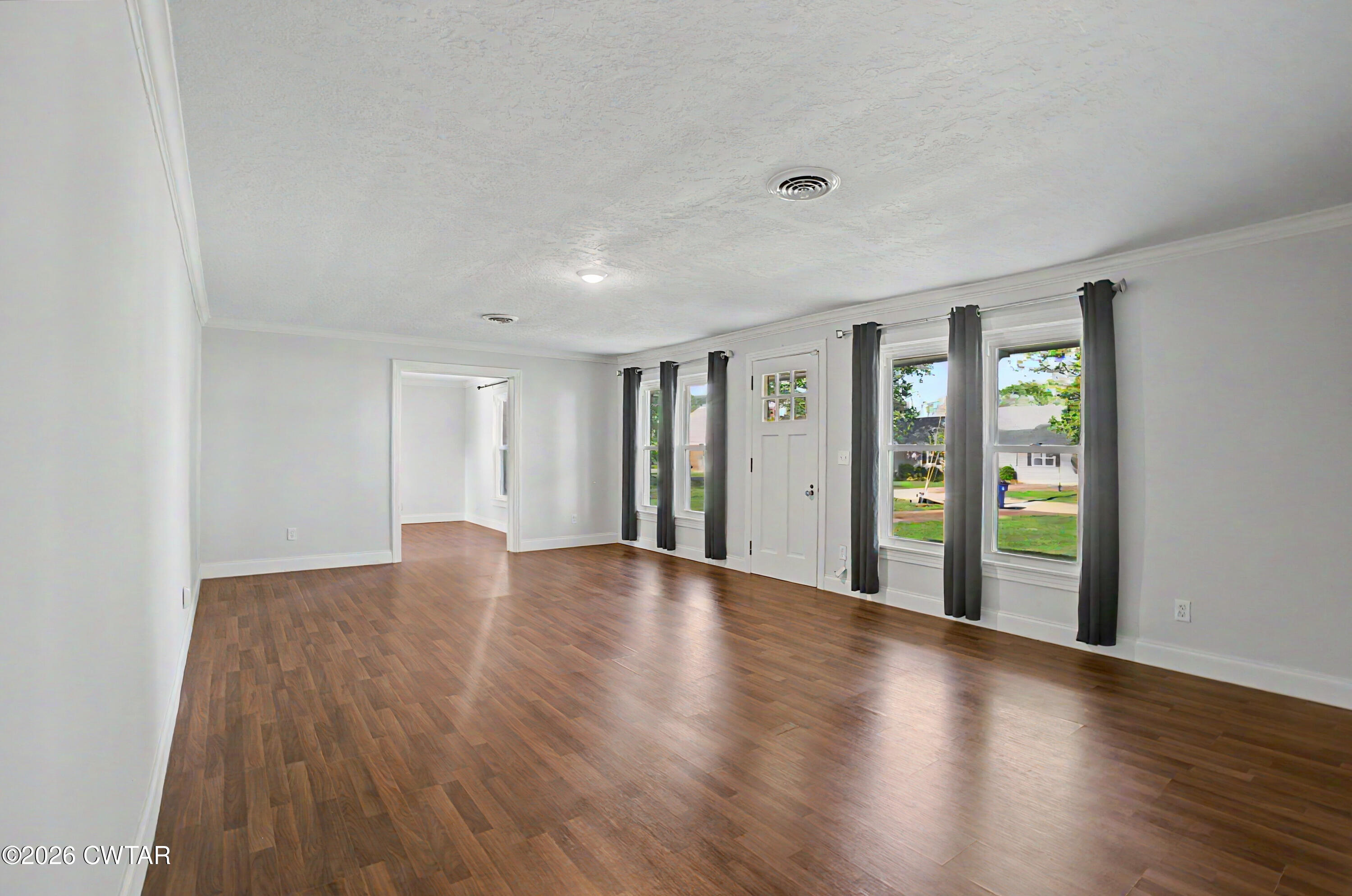 113 Church Street Gleason, TN 38229 - Photo 16 of 21 a view of an empty room with window and wooden floor