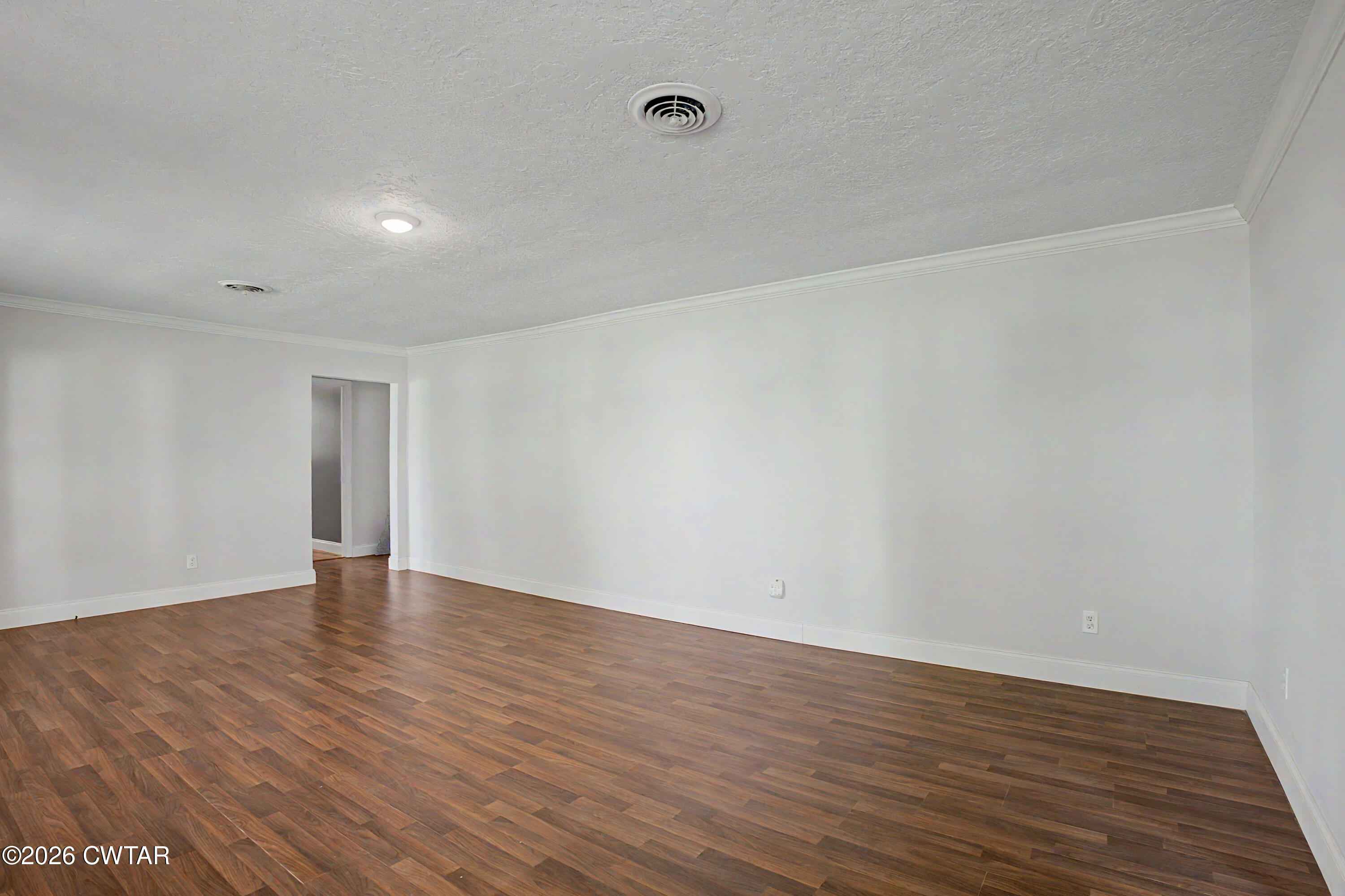 113 Church Street Gleason, TN 38229 - Photo 17 of 21 a view of an empty room with wooden floor and a window