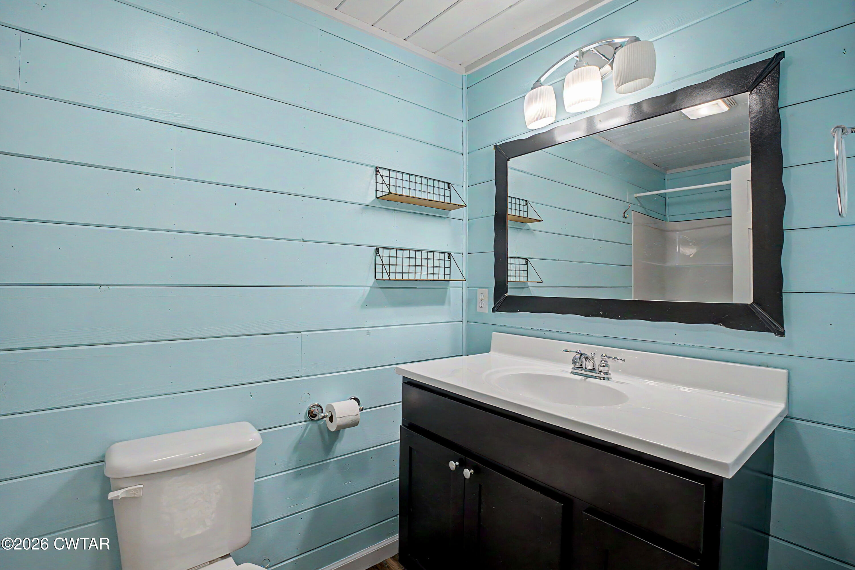 113 Church Street Gleason, TN 38229 - Photo 19 of 21 a bathroom with a sink a toilet and mirror