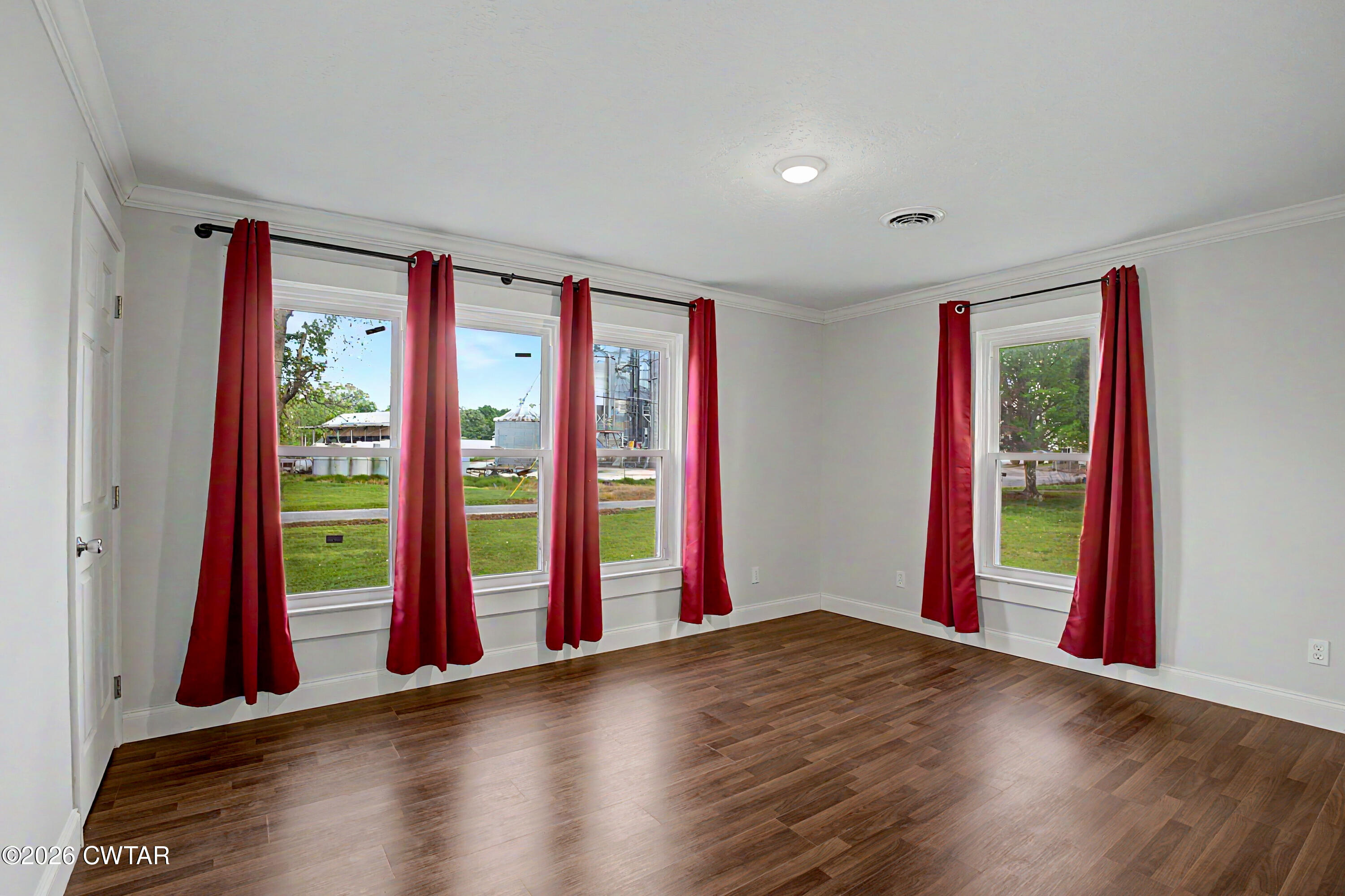 113 Church Street Gleason, TN 38229 - Photo 4 of 21 a view of an empty room with window and wooden floor