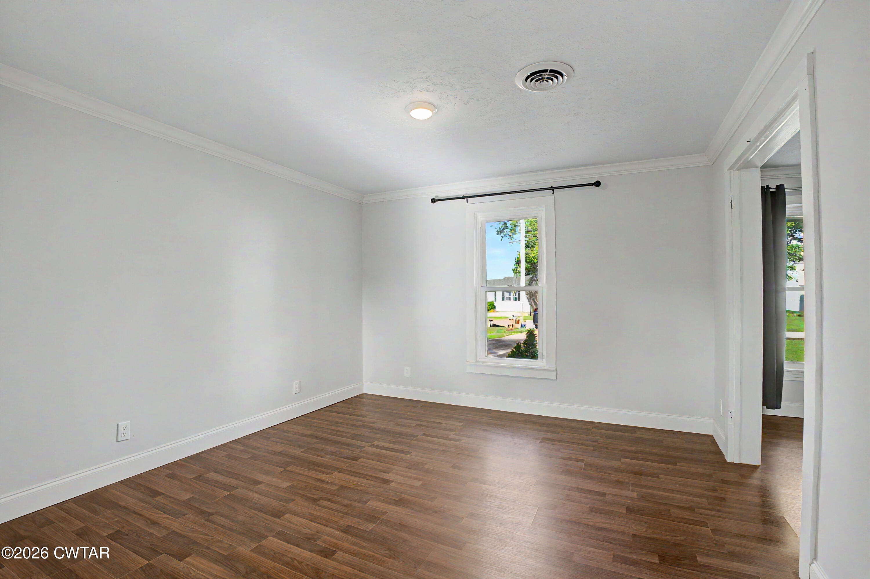 113 Church Street Gleason, TN 38229 - Photo 6 of 21 an empty room with window and wooden floor