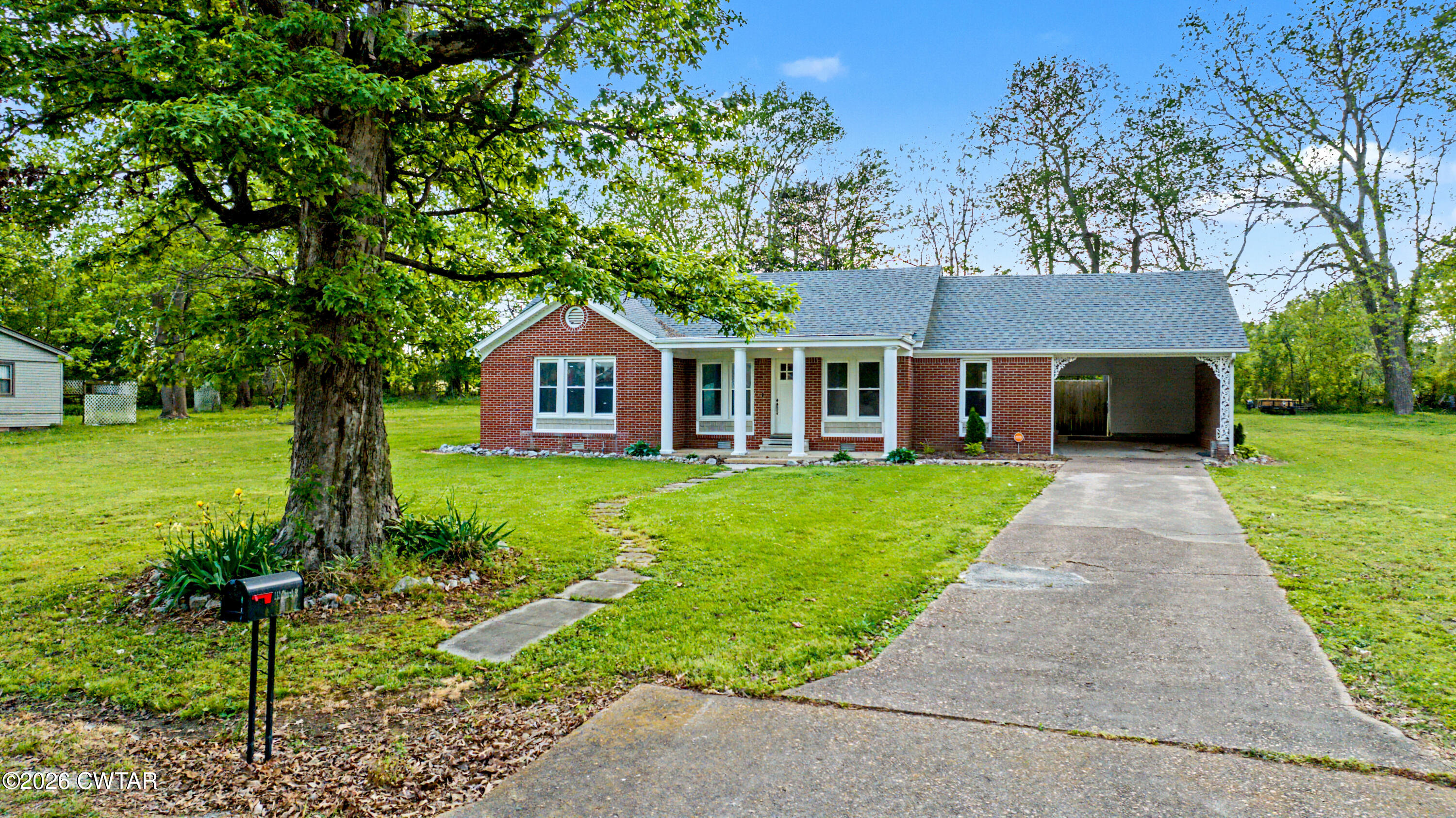 113 Church Street Gleason, TN 38229 - Photo 7 of 21 a front view of a house with a yard and trees
