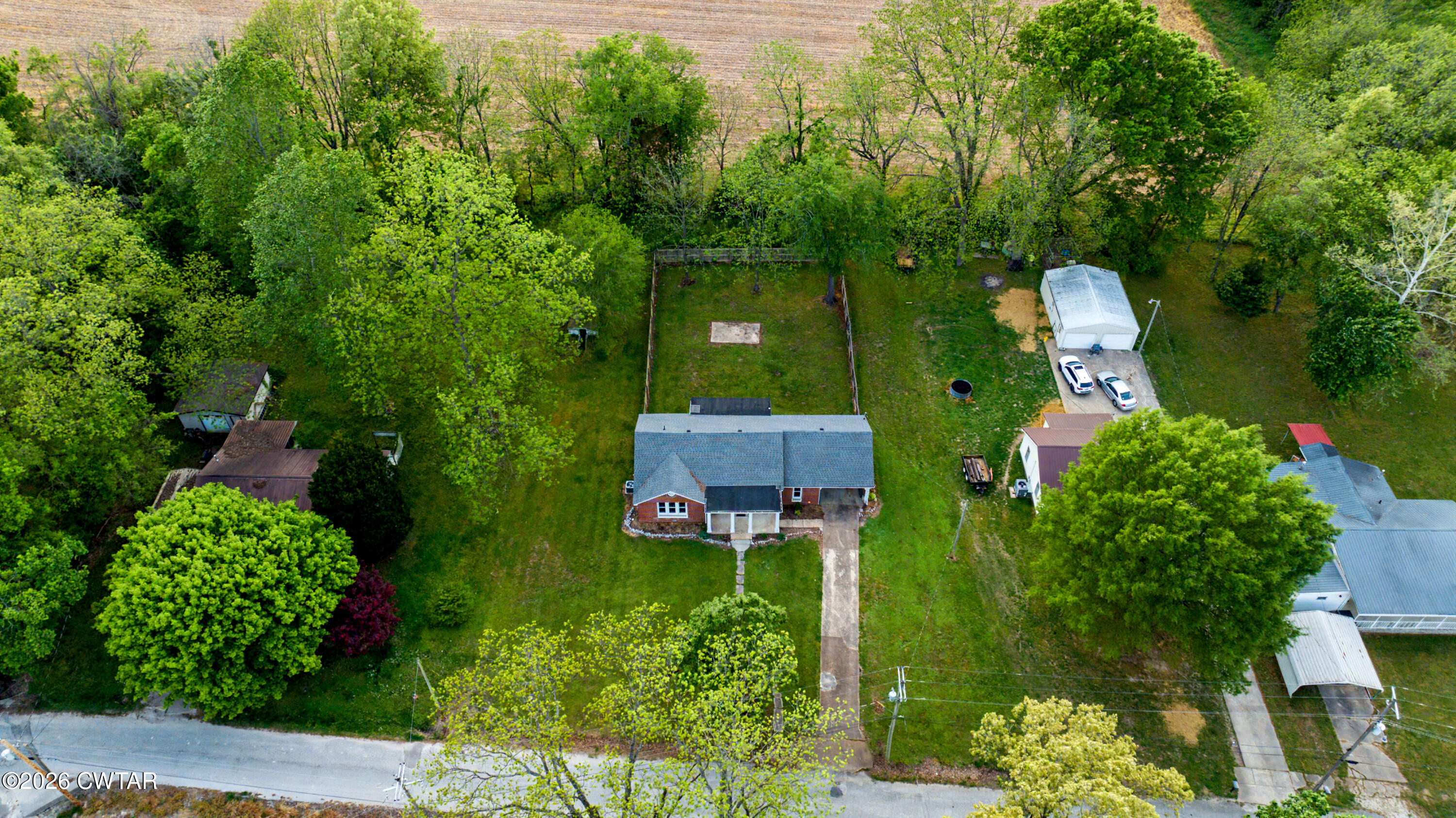 113 Church Street Gleason, TN 38229 - Photo 8 of 21 an aerial view of a house with a yard and large trees