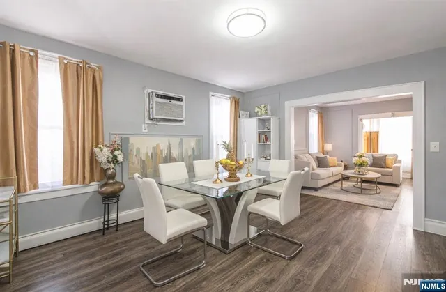 a view of a dining room with furniture wooden floor and a rug