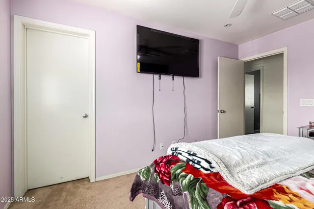 a bedroom with a bed and a flat screen tv