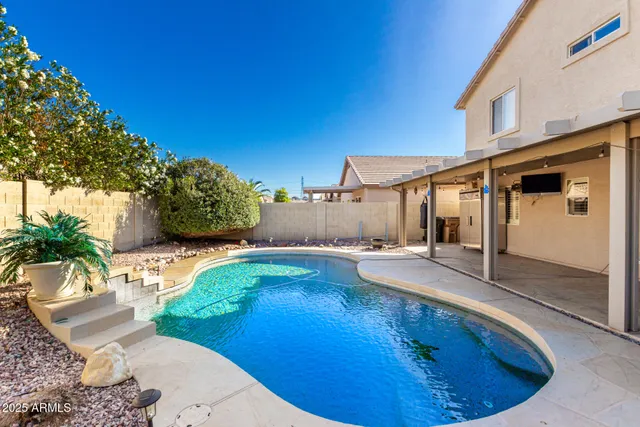 a view of a backyard with plants and a patio