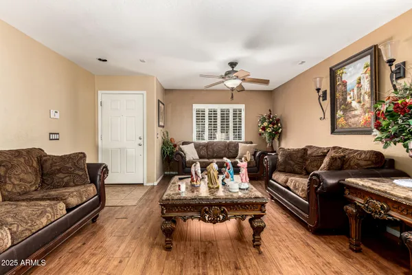 a living room with furniture fireplace and a window