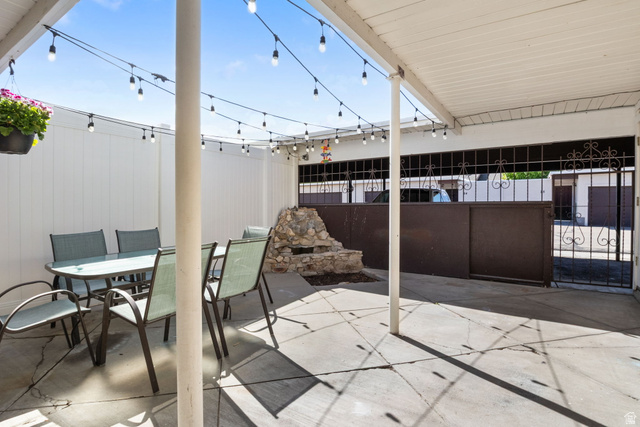 41 Benchmark Village Tooele, UT 84074 - Photo 23 of 26 View of patio / terrace with outdoor dining space and a gate