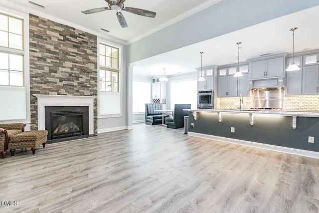 a large kitchen with stainless steel appliances granite countertop a sink a stove and a refrigerator