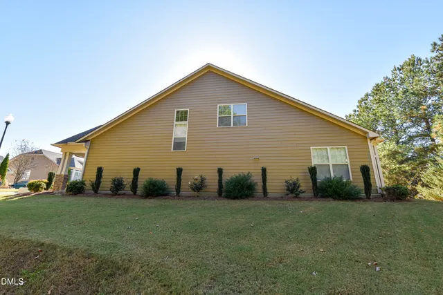 a front view of a house with a garden