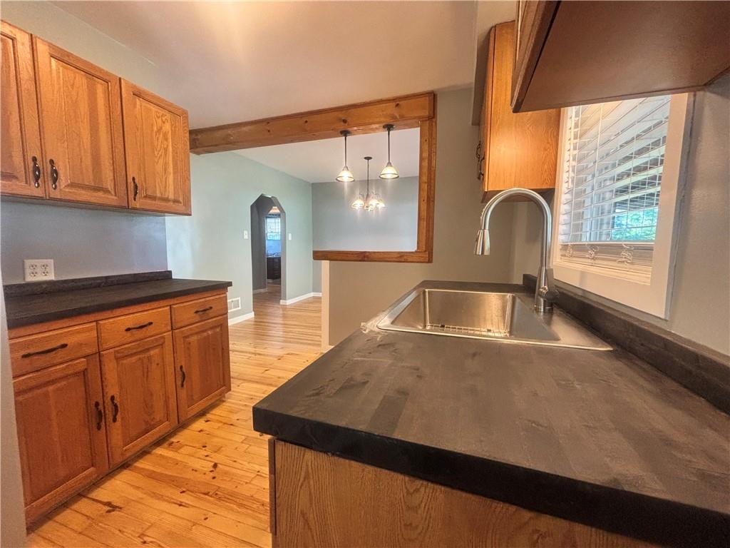 26 Mt View Drive Burgettstown, PA 15021 - Photo 29 of 45 a kitchen with stainless steel appliances granite countertop a sink a stove and a wooden floors