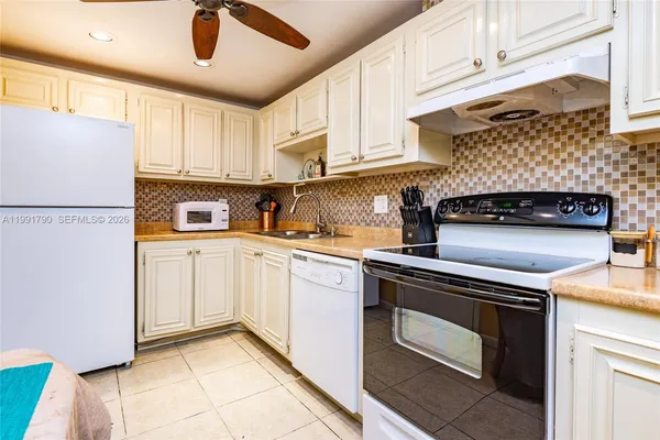a kitchen with a stove cabinets and a refrigerator