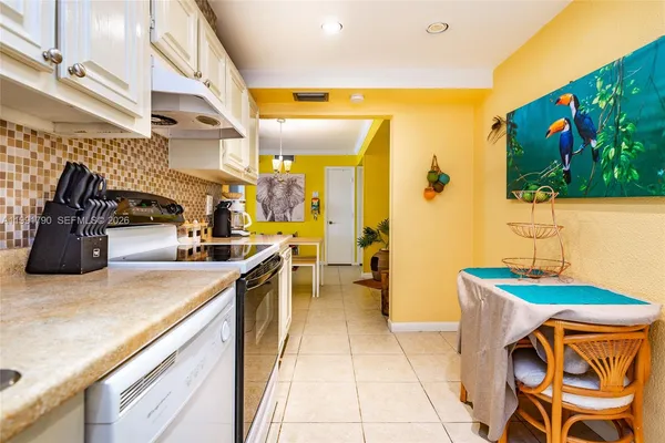 a kitchen with stainless steel appliances granite countertop sink stove top oven and cabinets