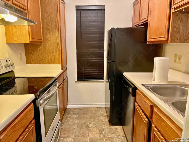a bathroom with a granite countertop sink and a washing machine