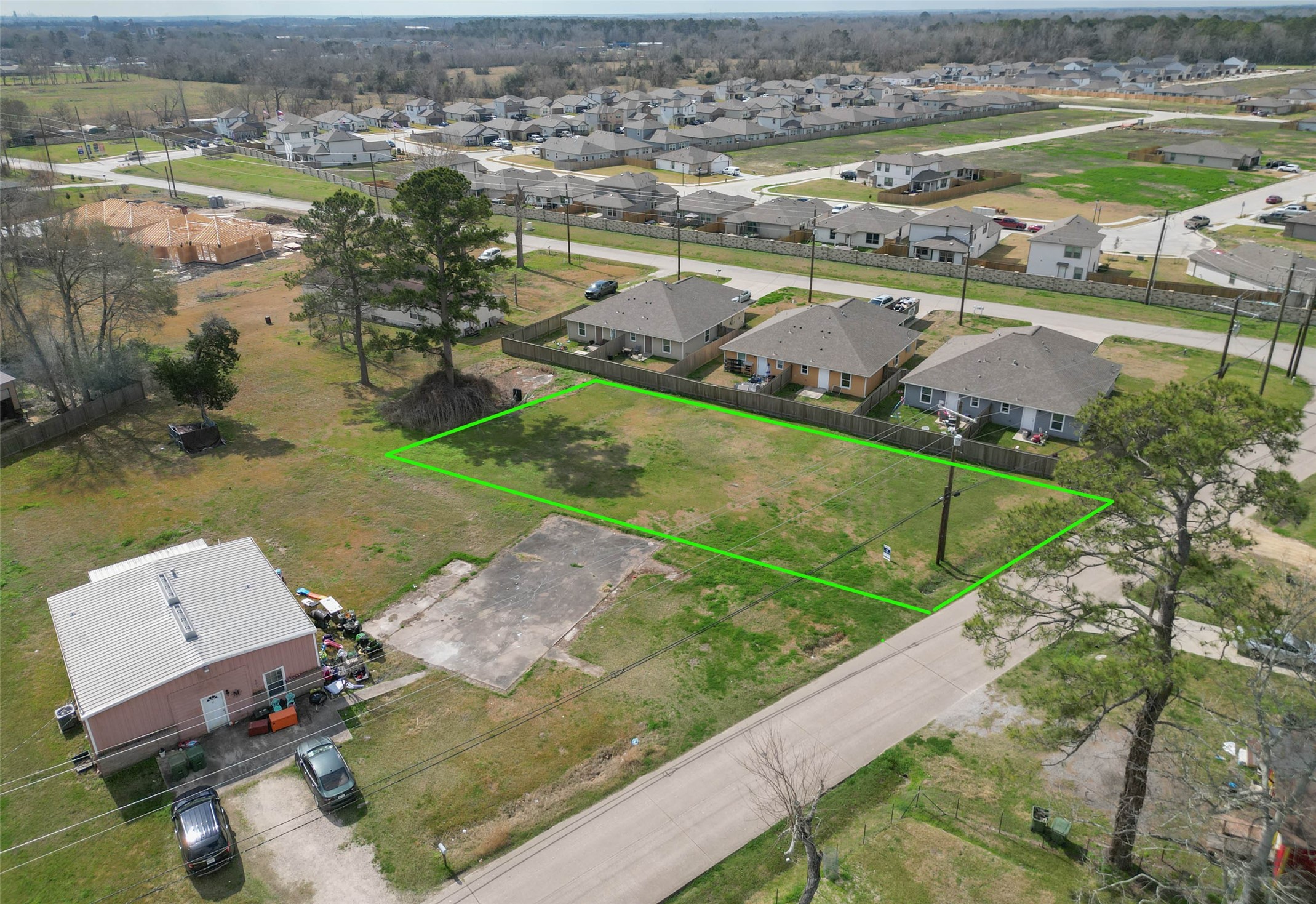 an aerial view of residential houses with outdoor space and lake view