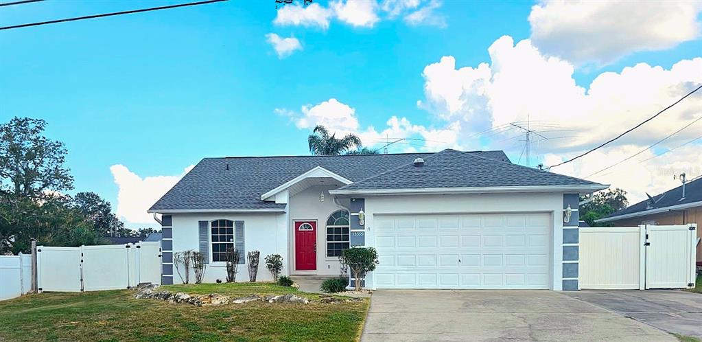 13599 Southeast 51st Terrace Summerfield, FL 34491 - Photo 1 of 44 a front view of a house with a yard and garage