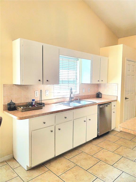 13599 Southeast 51st Terrace Summerfield, FL 34491 - Photo 12 of 44 a kitchen with granite countertop white cabinets sink and white appliances
