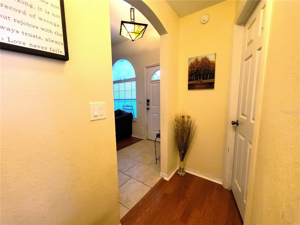 13599 Southeast 51st Terrace Summerfield, FL 34491 - Photo 14 of 44 a view of a hallway with wooden shelves