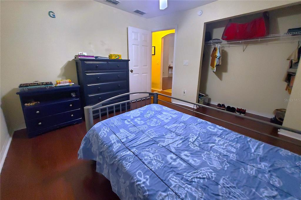 13599 Southeast 51st Terrace Summerfield, FL 34491 - Photo 17 of 44 a bed room with a bed and a television