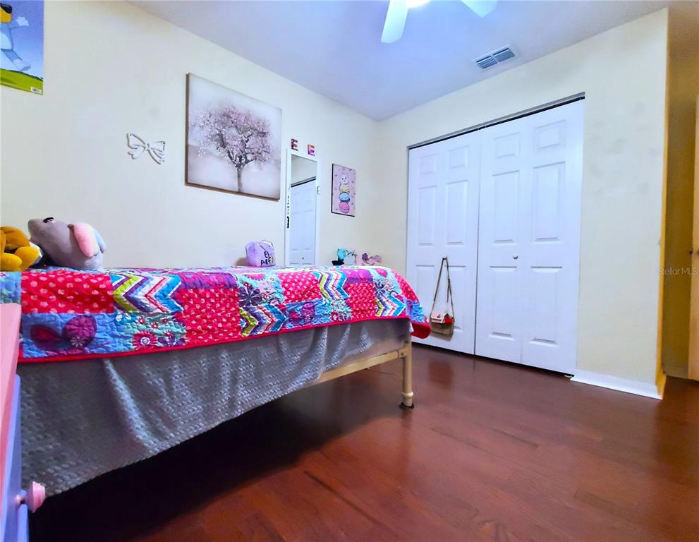13599 Southeast 51st Terrace Summerfield, FL 34491 - Photo 21 of 44 a bedroom with a bed a dresser and paintings on the wall