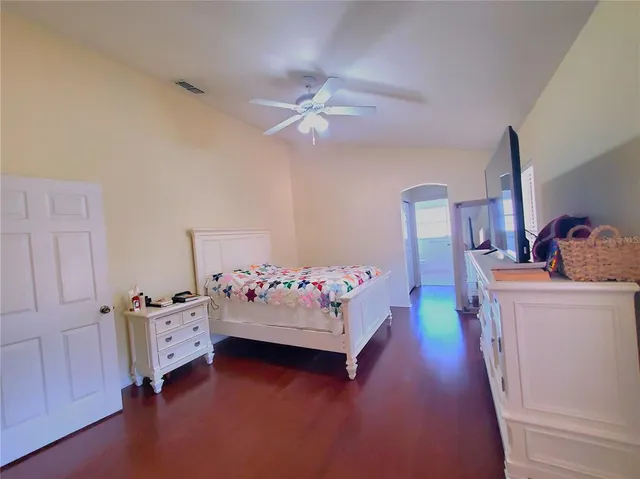 a view of a hallway with wooden floor and closet area