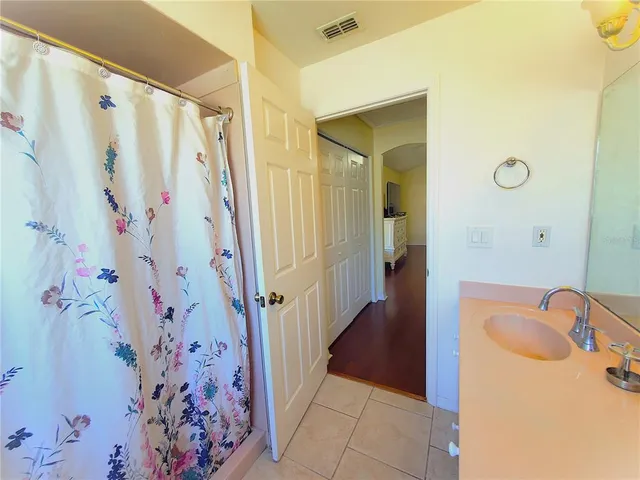 a bathroom with a sink toilet and window