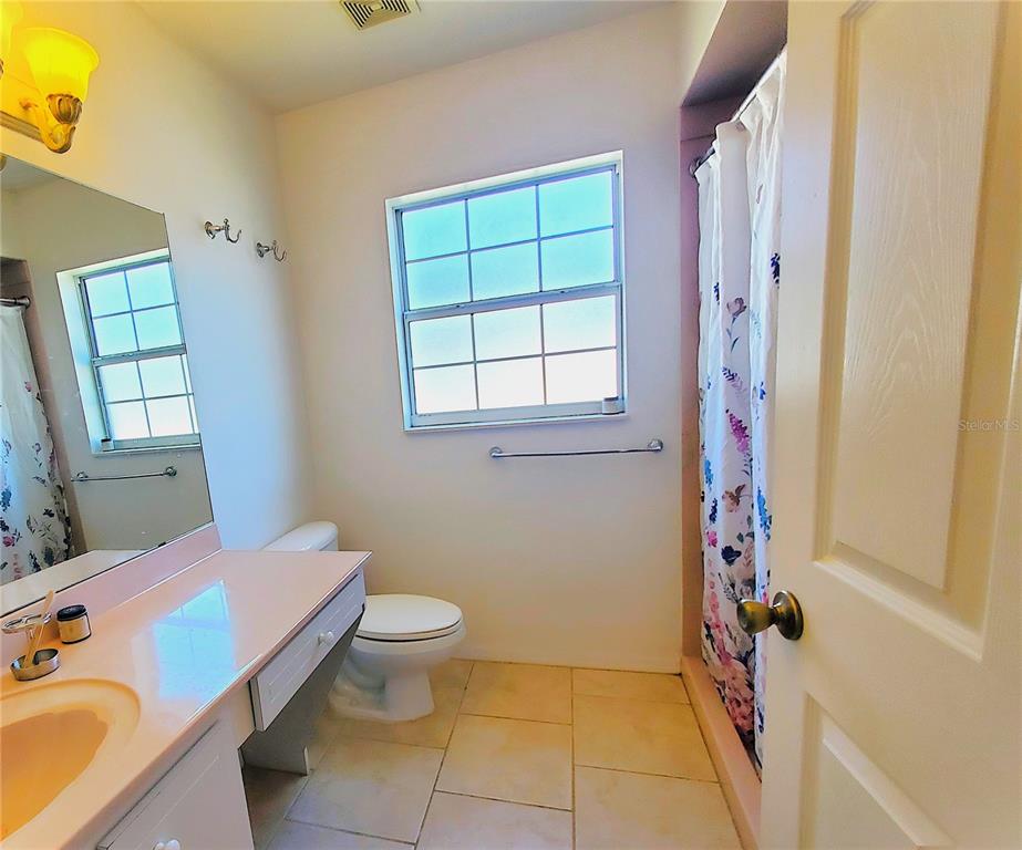 13599 Southeast 51st Terrace Summerfield, FL 34491 - Photo 28 of 44 a bathroom with a sink toilet and window
