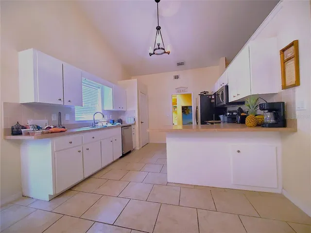 a kitchen with cabinets and steel stainless steel appliances