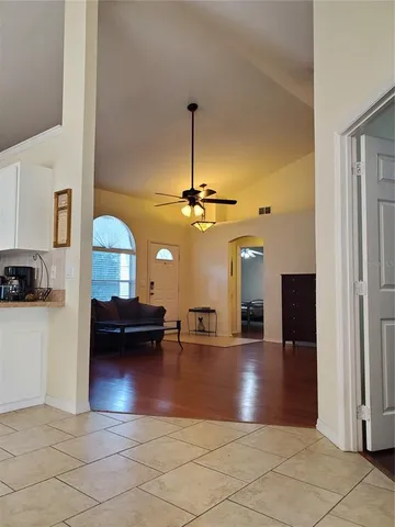 a room with a washing machine and a view of bedroom