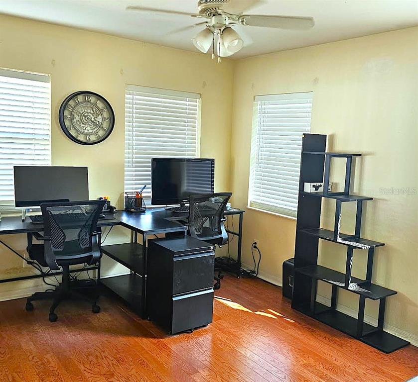 13599 Southeast 51st Terrace Summerfield, FL 34491 - Photo 43 of 44 a view of a workspace with furniture and a window