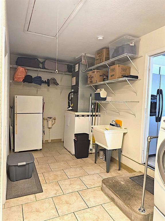 13599 Southeast 51st Terrace Summerfield, FL 34491 - Photo 44 of 44 a room with a washing machine and a view of bedroom