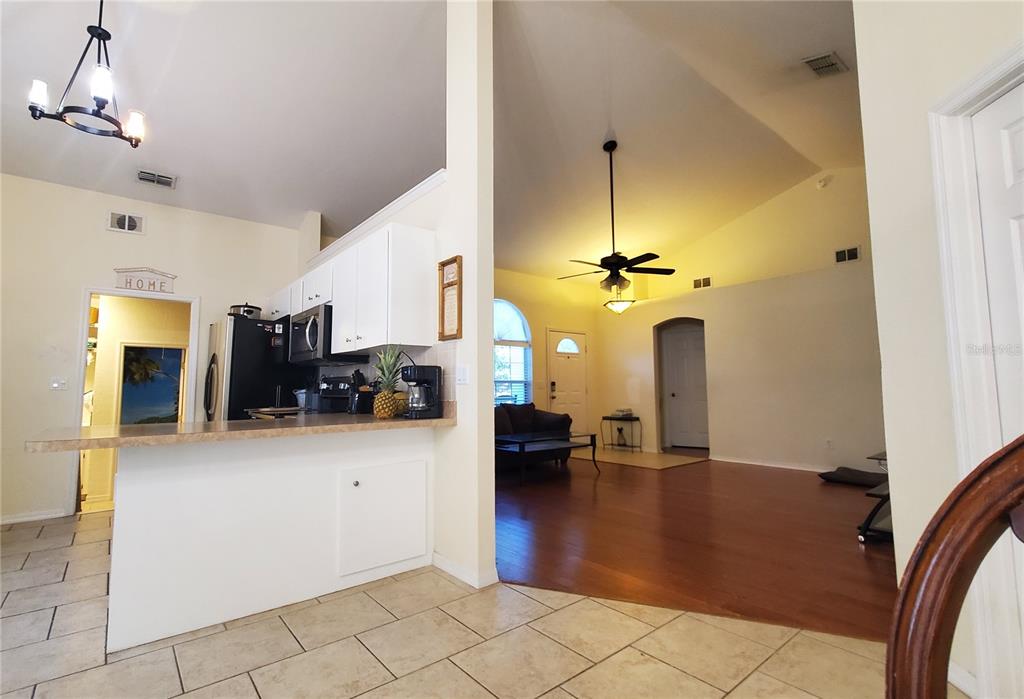 13599 Southeast 51st Terrace Summerfield, FL 34491 - Photo 8 of 44 a view of a livingroom with furniture and a ceiling fan