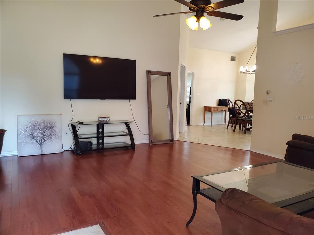 13599 Southeast 51st Terrace Summerfield, FL 34491 - Photo 10 of 44 a living room with furniture and a flat screen tv
