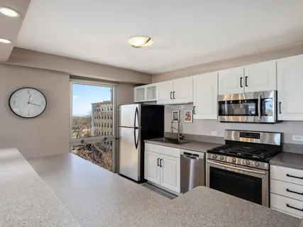 a kitchen with stainless steel appliances a stove a sink and a refrigerator