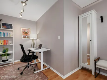 a workspace room with furniture and wooden floor