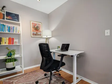 a view of a workspace with furniture and a potted plant