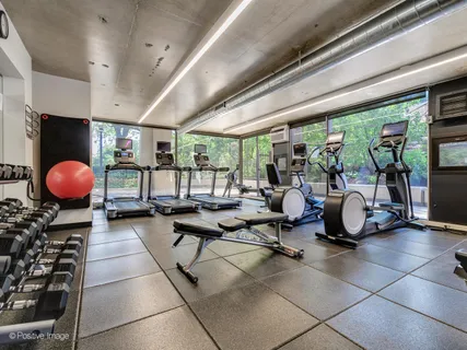 a room with gym equipment and large window