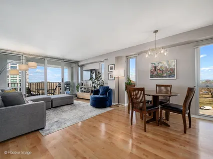 a living room with furniture dining area and a chandelier