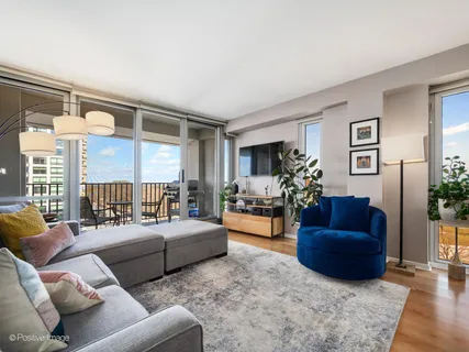 a living room with furniture fireplace and a large window