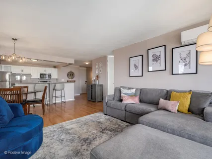 a living room with furniture and view of kitchen