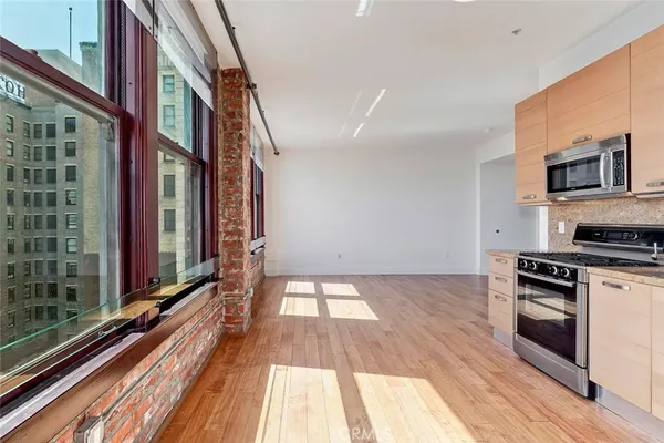 a view of an empty room and wooden floor